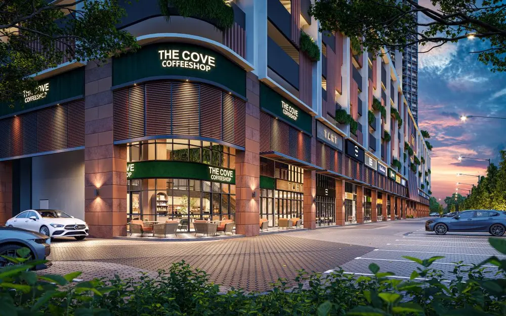 The Straits View DUO retail podium at dusk, showing The Cove Coffeeshop and other ground-floor tenants